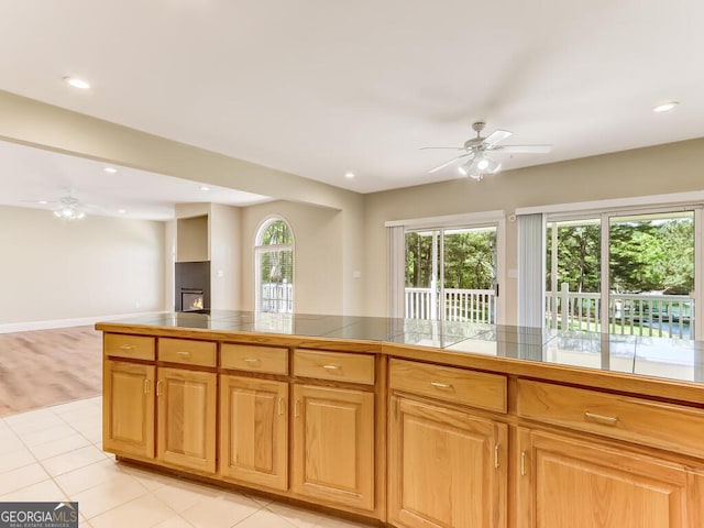 kitchen featuring ceiling fan and light hardwood / wood-style floors