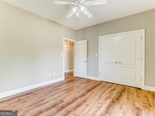 unfurnished bedroom with light wood-type flooring, a closet, and ceiling fan