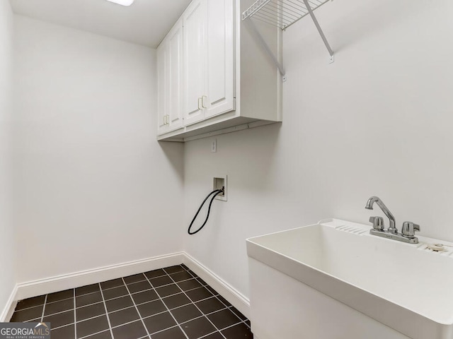 laundry room with cabinets, washer hookup, dark tile patterned flooring, and sink