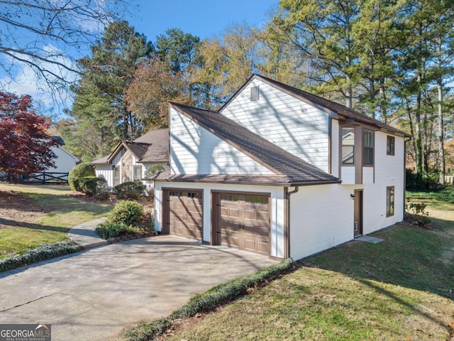 view of side of home featuring a lawn and a garage