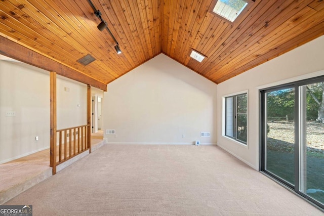 additional living space featuring ceiling fan, light colored carpet, lofted ceiling with skylight, and wooden ceiling