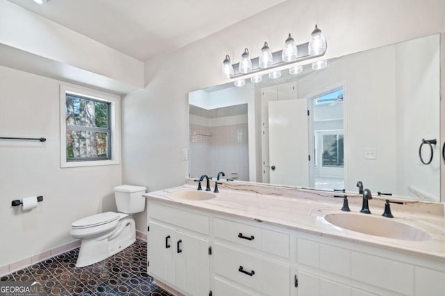 bathroom with tile patterned floors, vanity, toilet, and ceiling fan