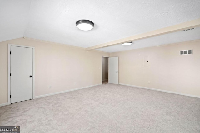 interior space featuring light carpet, a textured ceiling, electric panel, and lofted ceiling