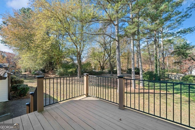 wooden deck with a lawn