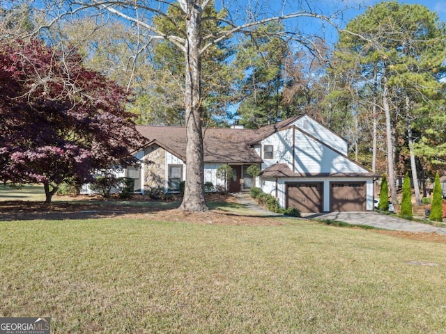 view of front of home with a garage and a front lawn