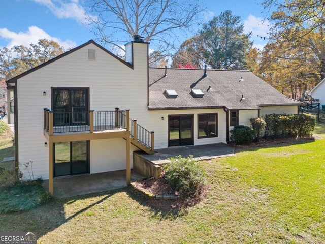 back of house with a patio area and a yard