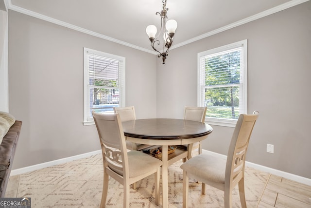 dining room with ornamental molding and a notable chandelier