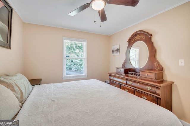 bedroom with ceiling fan, ornamental molding, and multiple windows