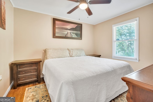 bedroom with ceiling fan, light hardwood / wood-style flooring, and crown molding