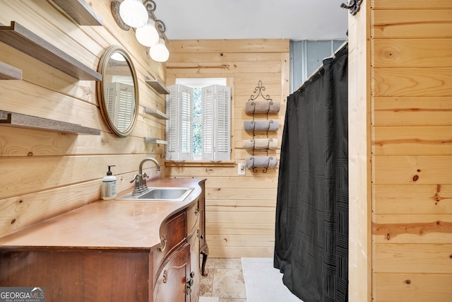 bathroom featuring wooden walls, tile patterned flooring, and vanity