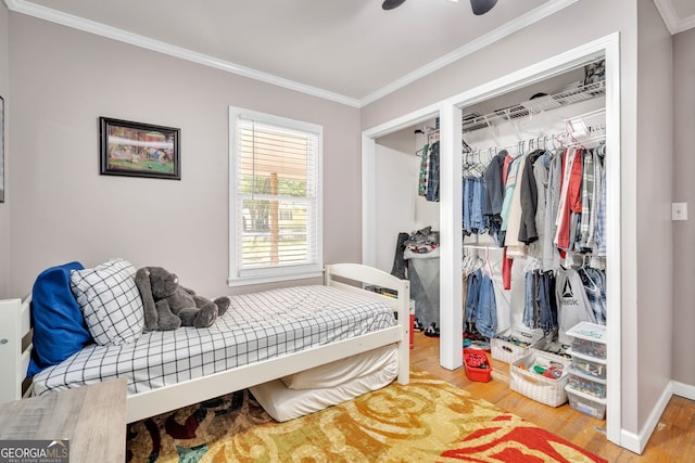 bedroom featuring ceiling fan, wood-type flooring, and ornamental molding