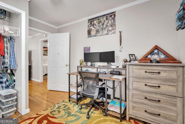 office space with ornamental molding and light wood-type flooring