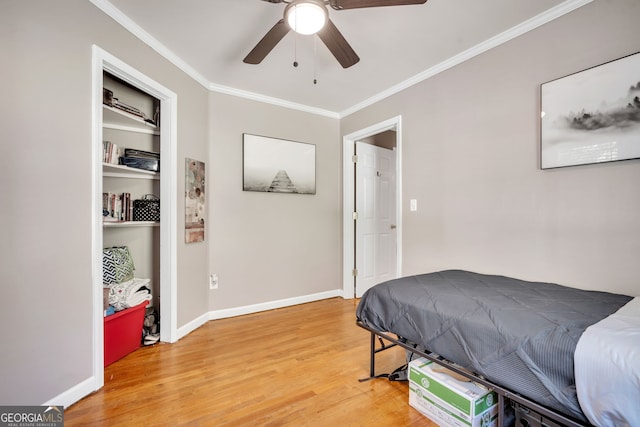 bedroom with hardwood / wood-style flooring, ceiling fan, and ornamental molding