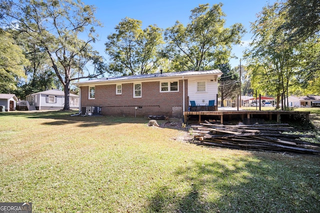 rear view of house with a yard and cooling unit