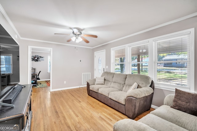 living room with light hardwood / wood-style flooring, ceiling fan, and crown molding