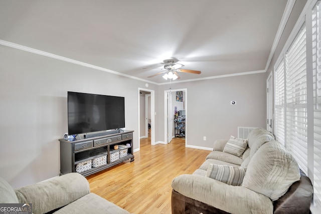 living room featuring crown molding, ceiling fan, and wood-type flooring