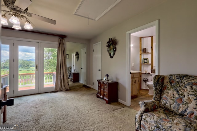 living area featuring ceiling fan and light carpet