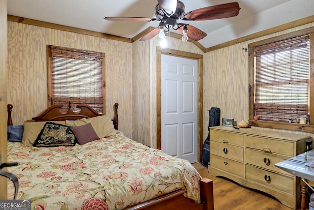 bedroom featuring ceiling fan, wood-type flooring, and lofted ceiling