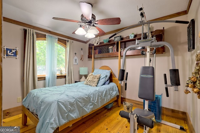 bedroom with ceiling fan, light hardwood / wood-style flooring, and crown molding