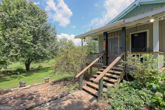 property entrance with a yard