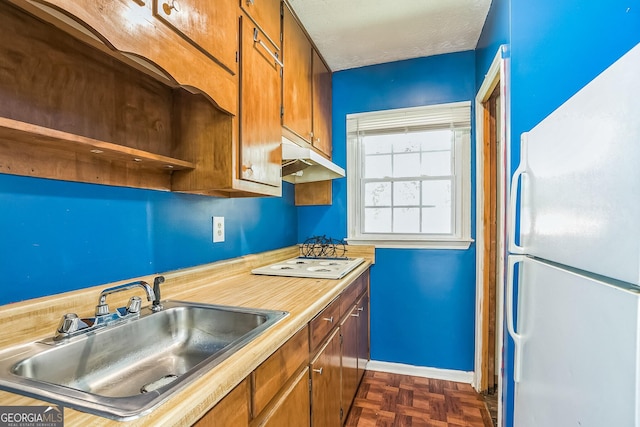 kitchen featuring a textured ceiling, sink, dark parquet floors, and white appliances