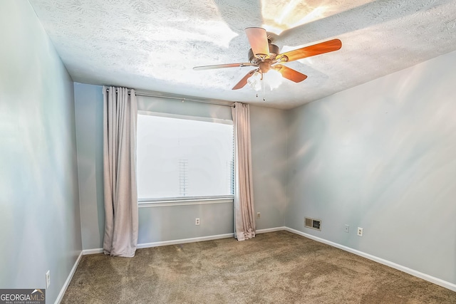 unfurnished room featuring ceiling fan, carpet, and a textured ceiling