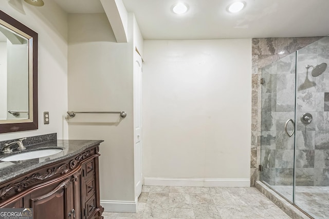 bathroom featuring vanity and a shower with door