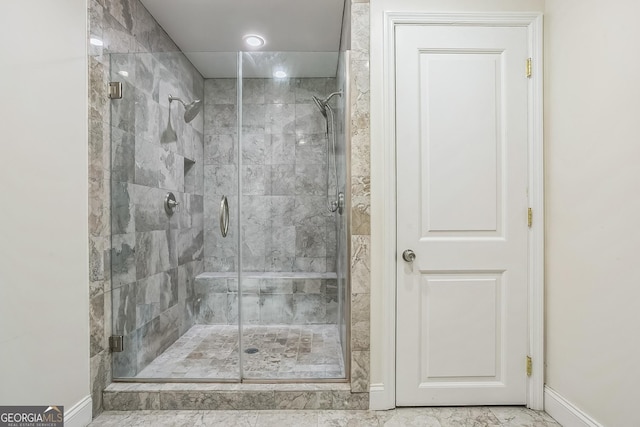 bathroom featuring a shower with door