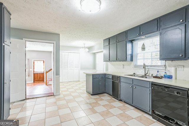 kitchen with a textured ceiling, dishwasher, sink, and backsplash