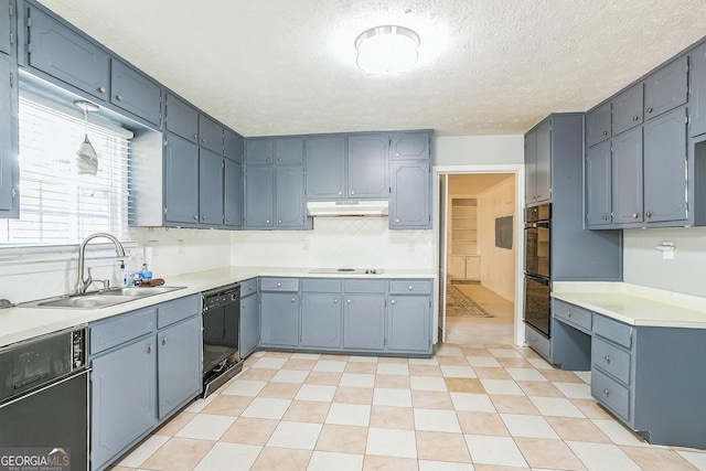 kitchen featuring sink, black appliances, and a textured ceiling