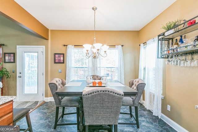 dining area featuring a notable chandelier