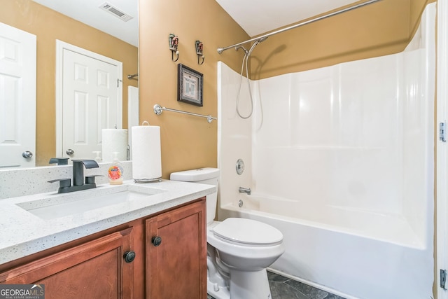 full bathroom featuring washtub / shower combination, vanity, toilet, and tile patterned flooring