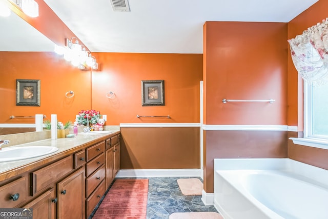 bathroom with a bathtub and vanity