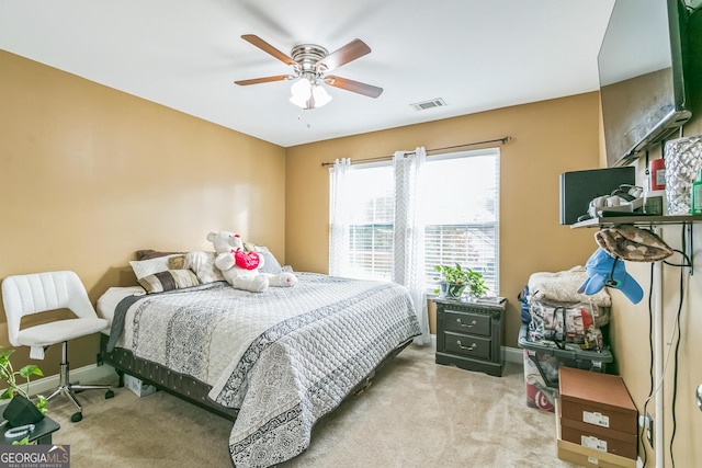 bedroom featuring ceiling fan and light carpet