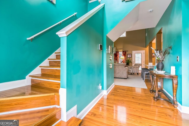 stairway with hardwood / wood-style floors