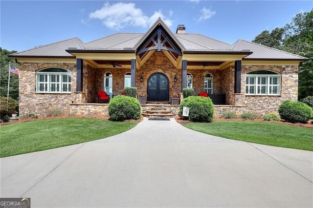 view of front facade with a front lawn and french doors