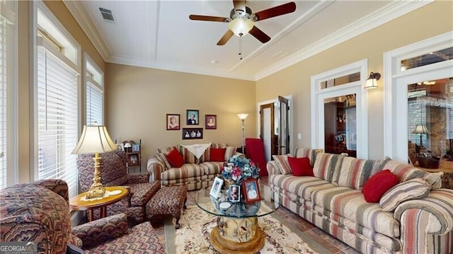 living room with ceiling fan and crown molding