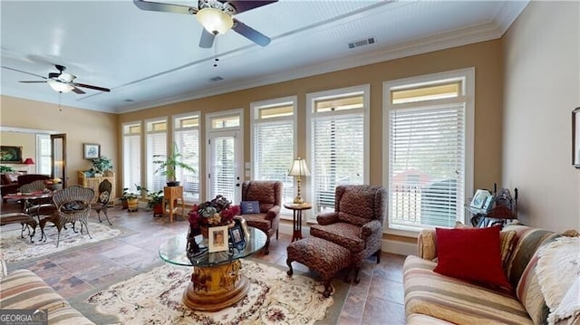 living room with ceiling fan, a healthy amount of sunlight, and ornamental molding