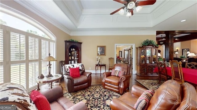 living room featuring hardwood / wood-style flooring, ceiling fan, and crown molding