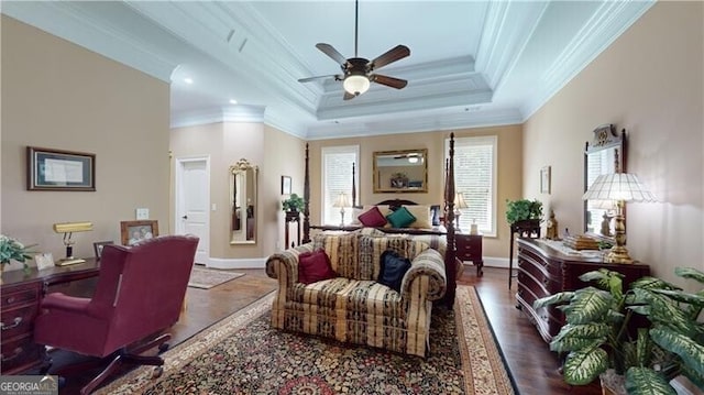 bedroom with ceiling fan, crown molding, dark wood-type flooring, and a tray ceiling