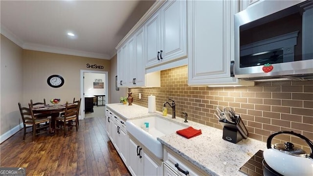 kitchen featuring white cabinets, dark hardwood / wood-style floors, and sink