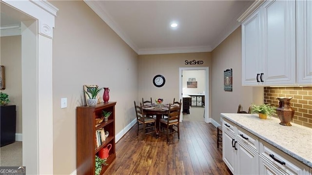 dining room with crown molding and dark wood-type flooring