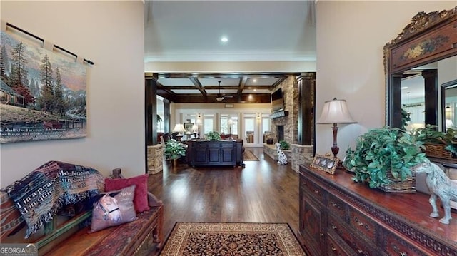 foyer featuring hardwood / wood-style floors, beam ceiling, ornamental molding, and coffered ceiling