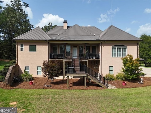 back of property with covered porch and a lawn