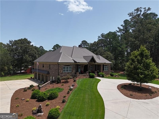 craftsman inspired home with a garage and a front lawn