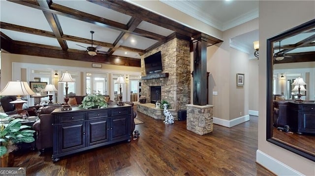 living room with ceiling fan, dark wood-type flooring, coffered ceiling, beamed ceiling, and a fireplace