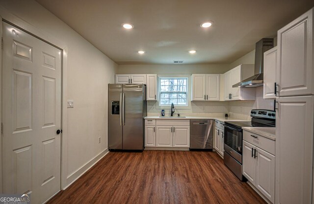 kitchen featuring dark hardwood / wood-style flooring, sink, white cabinetry, and stainless steel appliances