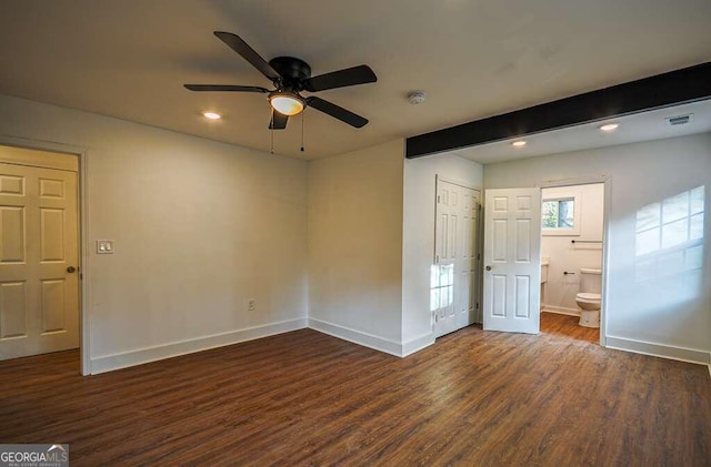 unfurnished bedroom with beamed ceiling, ceiling fan, dark hardwood / wood-style flooring, and ensuite bathroom