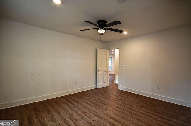 spare room featuring dark hardwood / wood-style floors and ceiling fan