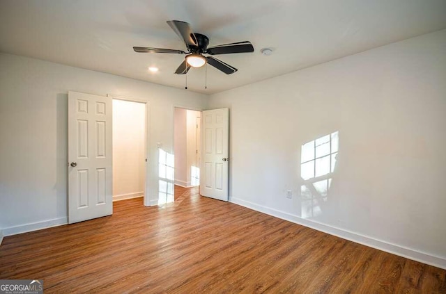 unfurnished bedroom with ceiling fan and light wood-type flooring